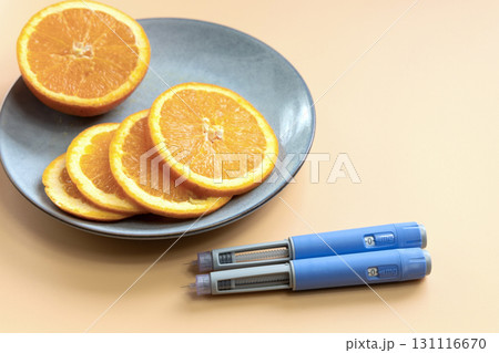 Two Insulin injection pen for diabetics and weight loss and plate with orange Two Insulin injection pen for diabetics and weight loss and plate with orange 131116670