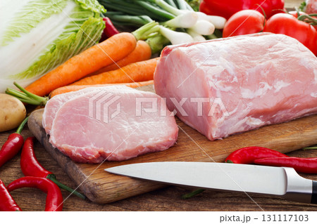 Vegetables and pork meat on cutting board 131117103