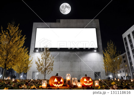 halloween advertisement with a blank white billboard and jack o lanterns on a city street at night 131118616