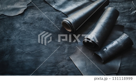 Black natural leather rolls and sheets on dark background Black natural leather rolls and sheets on dark background 131118999