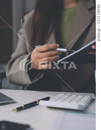 Portrait of young Hispanic professional business woman standing in office. Happy female company executive, smiling businesswoman entrepreneur corporate leader manager looking at camera using tablet Portrait of young Hispanic professional business woman standing in office. Happy female company executive, smiling businesswoman entrepreneur corporate leader manager looking at camera using tablet 131119056