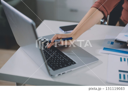 Portrait of young Hispanic professional business woman standing in office. Happy female company executive, smiling businesswoman entrepreneur corporate leader manager looking at camera using tablet 131119083