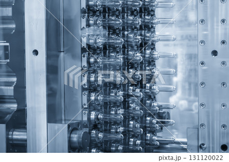 Close up scene of injection process group of preform shape of PET bottle products in the blue scene. Close up scene of injection process group of preform shape of PET bottle products in the blue scene. 131120022