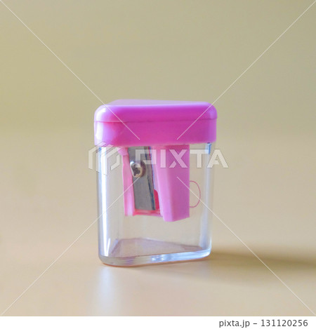 Pink pencil-sharpener on a over color background. 131120256