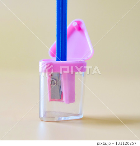 Pink pencil-sharpener on a over color background. 131120257