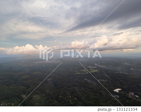 View of lush green valley beneath cloudy sky 131121334