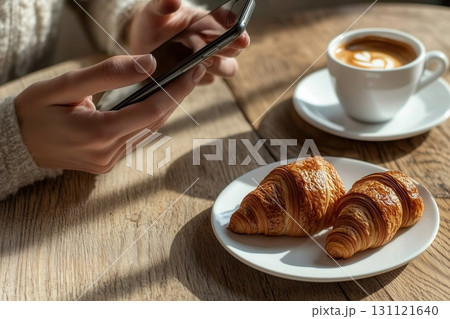 Smartphone with coffee cup and croissant 131121640