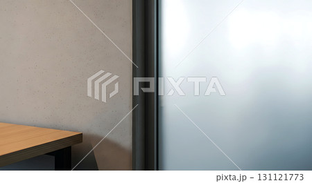 Office interior with part of a wooden desk, gray concrete wall, and frosted glass panel creating a modern and minimalistic atmosphere. Room lighting is soft and diffused 131121773