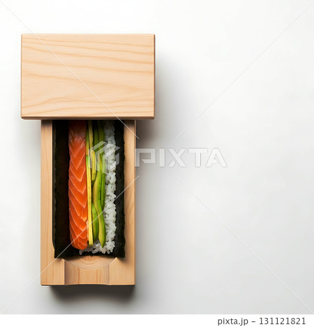 Rectangular wooden box partially open revealing sushi with salmon, avocado, and rice wrapped in seaweed. Minimalist presentation with a clean design focus 131121821