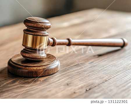 A wooden judge's gavel on a polished table, symbolizing law and justice. A wooden judge's gavel on a polished table, symbolizing law and justice. 131122301