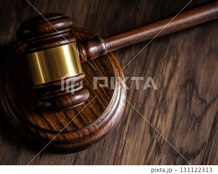 A wooden judge's gavel on a polished table, symbolizing law and justice. 131122313
