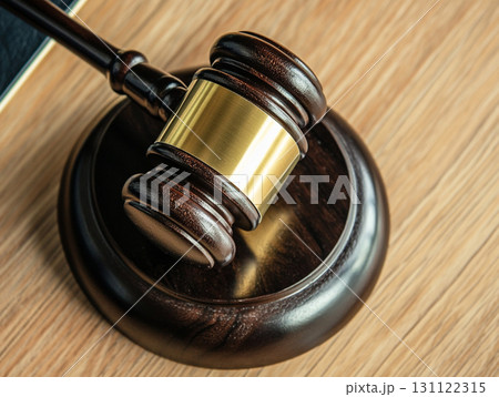 A wooden judge's gavel on a polished table, symbolizing law and justice. 131122315