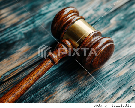 A wooden judge's gavel on a polished table, symbolizing law and justice. 131122316