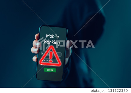 hacker holding a smartphone with a mobile banking login screen and red warning sign, phishing scams and cybersecurity threats in online financial systems. hacker holding a smartphone with a mobile banking login screen and red warning sign, phishing scams and cybersecurity threats in online financial systems. 131122380