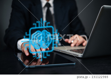 Businessman using digital tablet and laptop, with holographic brain icon artificial intelligence. concept innovation, data processing, machine learning, and technology AI, digital transformation. Businessman using digital tablet and laptop, with holographic brain icon artificial intelligence. concept innovation, data processing, machine learning, and technology AI, digital transformation. 131122393