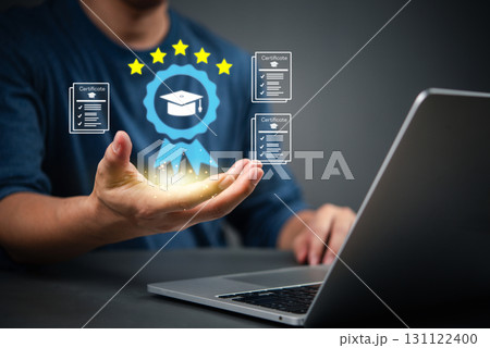 Man holding digital certificate icon with graduation cap, symbolizing online learning achievement. Concept of e-learning, remote education, and professional certification system. 131122400