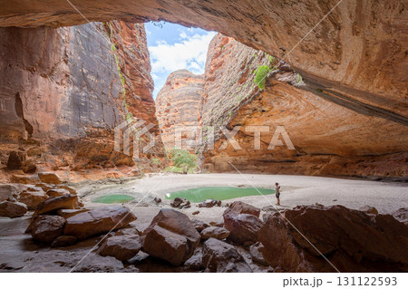 A person explores a stunning natural gorge in Western Australia.. A person explores a stunning natural gorge in Western Australia.. 131122593