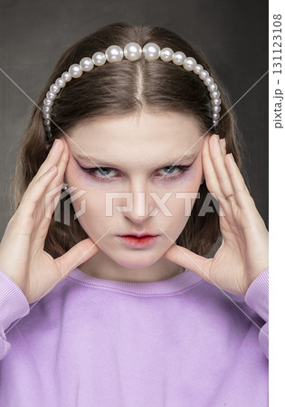The face of a serious female model with creative makeup. 131123108