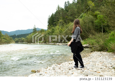 Teen Girl Walking Along the River in Nature Teen Girl Walking Along the River in Nature 131123139
