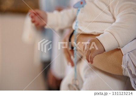 Baby in Hospital Cradle. Infant Monitoring, Medical Equipment, Blue Accents, Pale Skin Tones, White Clothing, Close-Up, Healthcare Setting, Soft Focus. Baby in Hospital Cradle. Infant Monitoring, Medical Equipment, Blue Accents, Pale Skin Tones, White Clothing, Close-Up, Healthcare Setting, Soft Focus. 131123214