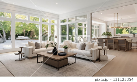 A modern, open-concept living room and kitchen with large windows overlooking a pool and garden, featuring white sofas, a wooden coffee table, and a dining area.  131123354