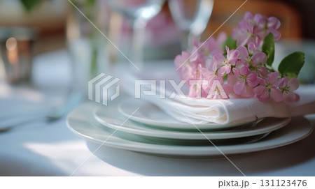 Delicate flowers adorn a beautifully set table for an elegant dining experience 131123476
