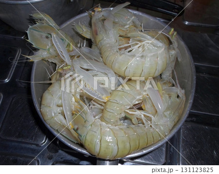 A Metal Pot Filled with Cooked Shrimp Ready to Serve in a Tropical Kitchen on a Stove 131123825