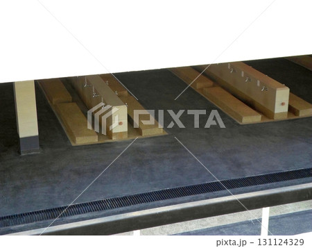 Indoor Shower Area with Wooden Benches and Drainage System in a Public Facility 131124329