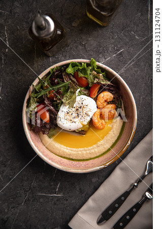 Bowl with hummus, egg, shrimp and salad 131124704