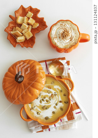 Autumnal flat lay with pumpkin soup, pumpkin latte, croutons and festive decor Autumnal flat lay with pumpkin soup, pumpkin latte, croutons and festive decor 131124837