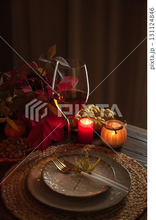Autumn Table Setting with Pumpkins, Candles and Leaf Decor Autumn Table Setting with Pumpkins, Candles and Leaf Decor 131124846