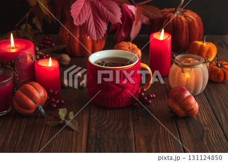 Cozy Autumn Scene with Mulled Wine, Candles, Pumpkins and Seasonal Decor 131124850