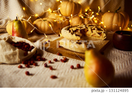 Warm Autumn Thanksgiving Table With Pies, Pumpkins, Pears And Fairy Lights 131124895