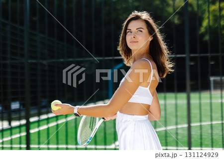 Female tennis player hitting forehand on a sunny day Female tennis player hitting forehand on a sunny day 131124929