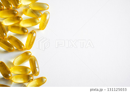 Omega-3 fish oil capsules on white background with healthy supplement concept 131125033