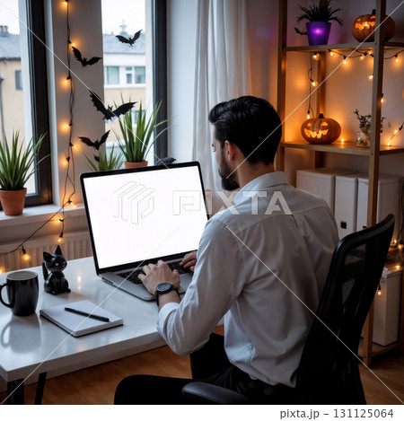 man working on laptop in apartment decorated for Halloween, shop window mockup, freelancing concept 131125064