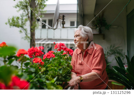 Cute old lady on balcony. 131125296
