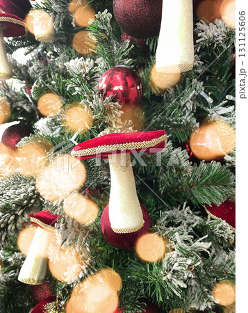 Christmas tree decorations with mushrooms and twinkling lights garland. Xmas holiday background. Festive winter trendy exterior for luxury store Christmas tree decorations with mushrooms and twinkling lights garland. Xmas holiday background. Festive winter trendy exterior for luxury store 131125606