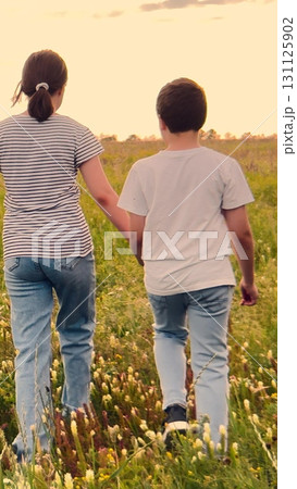 child parent, mother, father nature holding hand, happy family dream, Evening walk with loved ones, Siblings and parents, Sunset adventures together, Youth and adulthood, Living in harmony, Family 131125902