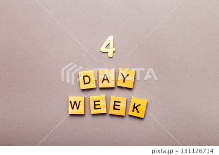 inscription four day week making by wooden cubes on grey background 131126714
