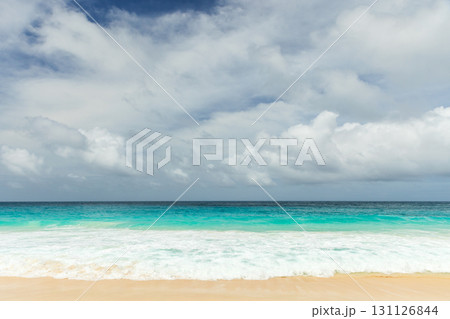 A tranquil beach scene with turquoise water, white sand, and gentle waves A tranquil beach scene with turquoise water, white sand, and gentle waves 131126844