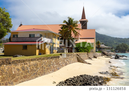 Saint Joseph, the Worker church is under cloudy sky on a sunny day. Anse Royale 131126858