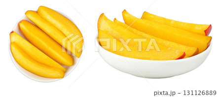 mango slices in ceramic bowl isolated on white background. Top view. Flat lay mango slices in ceramic bowl isolated on white background. Top view. Flat lay 131126889