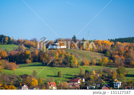 Krizova Hora near Cesky Krumlov with the Chapel of Our Lady of Sorrows at the summit. Captured in autumn with vibrant foliage and sunny weather highlighting its serene beauty Krizova Hora near Cesky Krumlov with the Chapel of Our Lady of Sorrows at the summit. Captured in autumn with vibrant foliage and sunny weather highlighting its serene beauty 131127187
