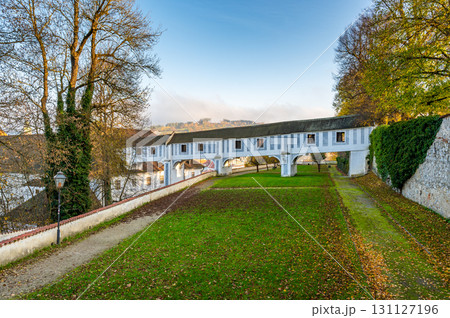Covered bridge from Cesky Krumlov Castle leading into the park, arching over a narrow alley. The historic structure adds a touch of charm to the peaceful surroundings 131127196