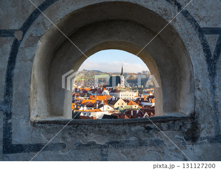 Church of St. Vitus in Cesky Krumlov surrounded by the historic town center. A sunny day with a clear blue sky highlights the charm of this UNESCO-listed medieval destination Church of St. Vitus in Cesky Krumlov surrounded by the historic town center. A sunny day with a clear blue sky highlights the charm of this UNESCO-listed medieval destination 131127200