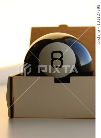 Black Billiard Ball With Number 8 In White Circle Lies In A White Box Stock Photo For Vertical Story  131127298