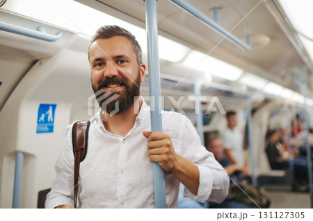 Man sitting in subway train, travelling to work. Man sitting in subway train, travelling to work. 131127305