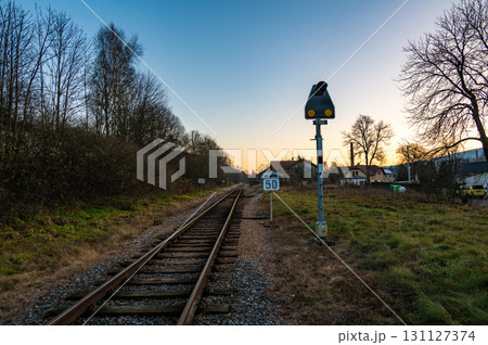 A nostalgic view of the railway tracks, signals, and station in the village of Bila Voda, depicting a small local line on the brink of closure, evoking a sense of history and transition 131127374