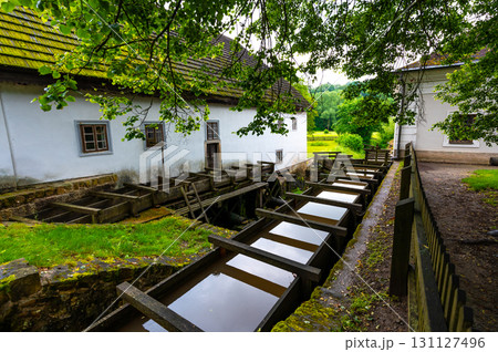The mill in Babiccino Valley is a historic structure set amidst lush nature, representing the rural heritage and charm of Bozena Nemcova's "Babicka," with its tranquil surroundings and scenic beauty. 131127496